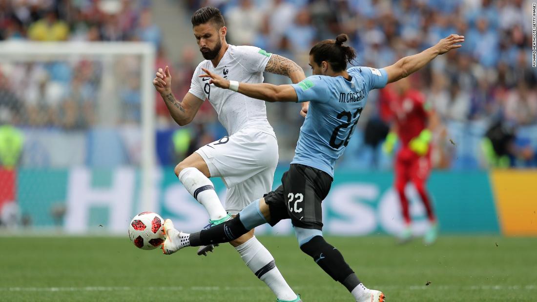 France&#39;s Olivier Giroud, left, and Uruguay&#39;s Martin Caceres battle for the ball during their quarterfinal match on July 6. France won 2-0.