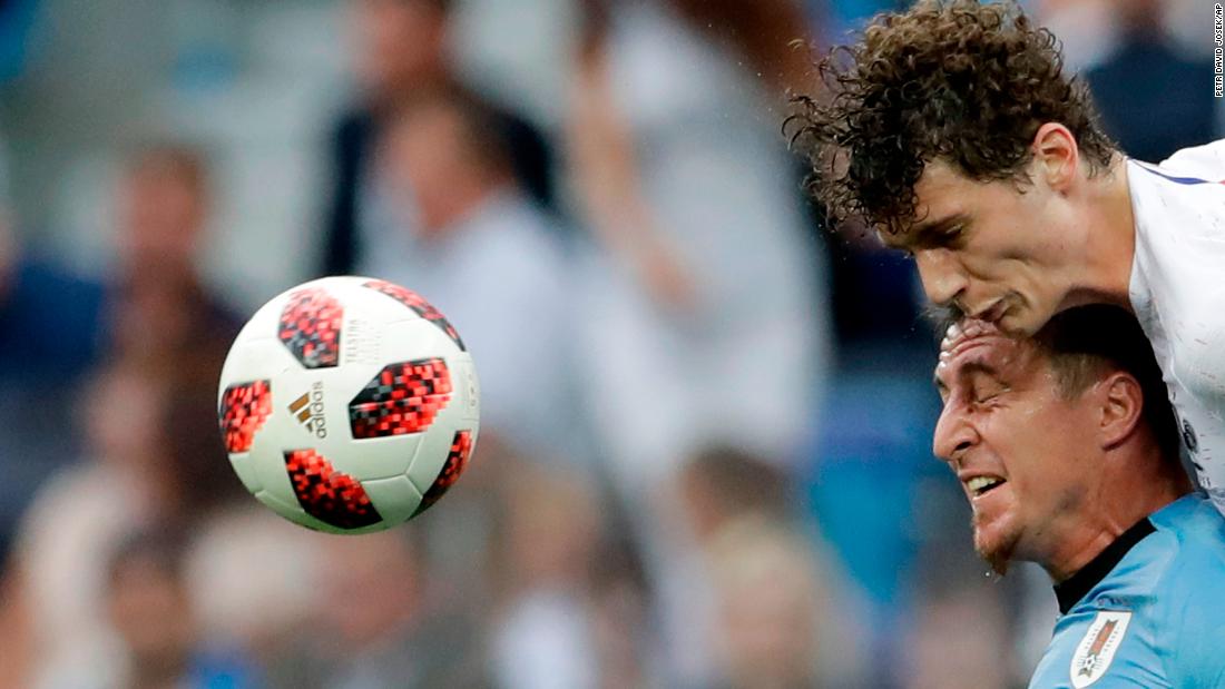 France&#39;s Benjamin Pavard, top, and Uruguay&#39;s Cristian Rodriguez compete for a header.