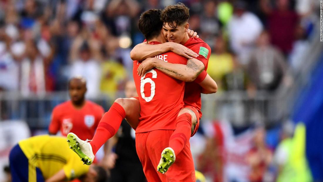 English defenders Harry Maguire, left, and John Stones celebrate their quarterfinal victory over Sweden on July 7. Maguire scored the opening goal in the 2-0 win.