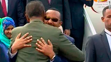 In this grab taken from video provided by ERITV, Ethiopia&#39;s Prime Minister Abiy Ahmed, background centre is welcomed by Eritrea&#39;s President Isaias Afwerki as he disembarks the plane, in Asmara, Eritrea, Sunday, July 8, 2018.
