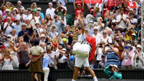 Roger Federer is applauded off court after his win over Adrian Mannarino at Wimbledon. 
