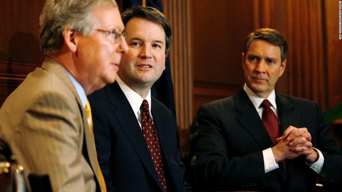 Kavanaugh is flanked by US Sens. Mitch McConnell, left, and Bill Frist during a news conference in Washington in May 2006. Kavanaugh had been nominated by Bush in 2003, but it took nearly three years until he was confirmed by a Senate vote of 57-36.