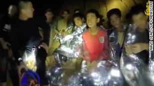 Members of the Royal Thai Navy are pictured with the 12 schoolboys members of a local soccer team and their coach who were trapped in the Tham Luang Cave network in Northern Thailand. 