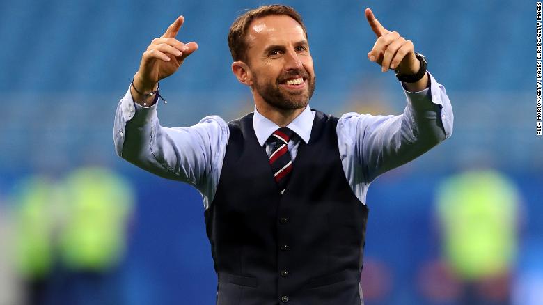 Gareth Southgate conducts the crowd as they sing a song to him.