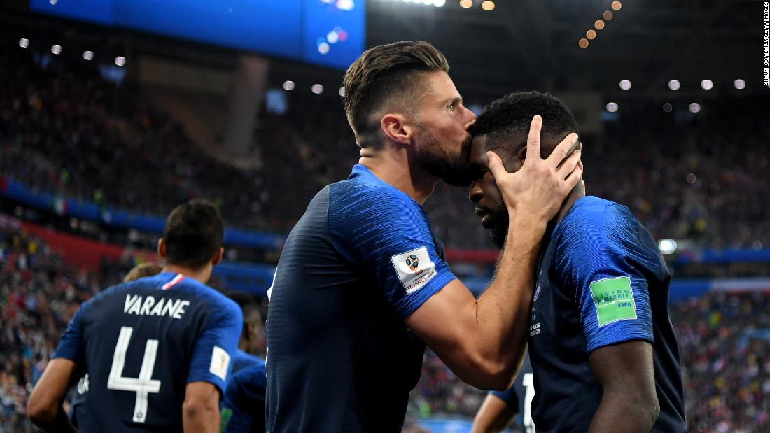 France&#39;s Olivier Giroud kisses teammate Samuel Umtiti after Umtiti scored on a header against Belgium.