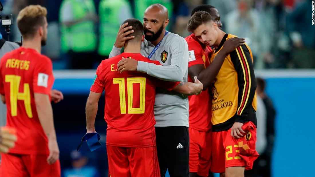 Thierry Henry, assistant coach for Belgium and former French captain, consoles Belgian players after the semifinal loss.