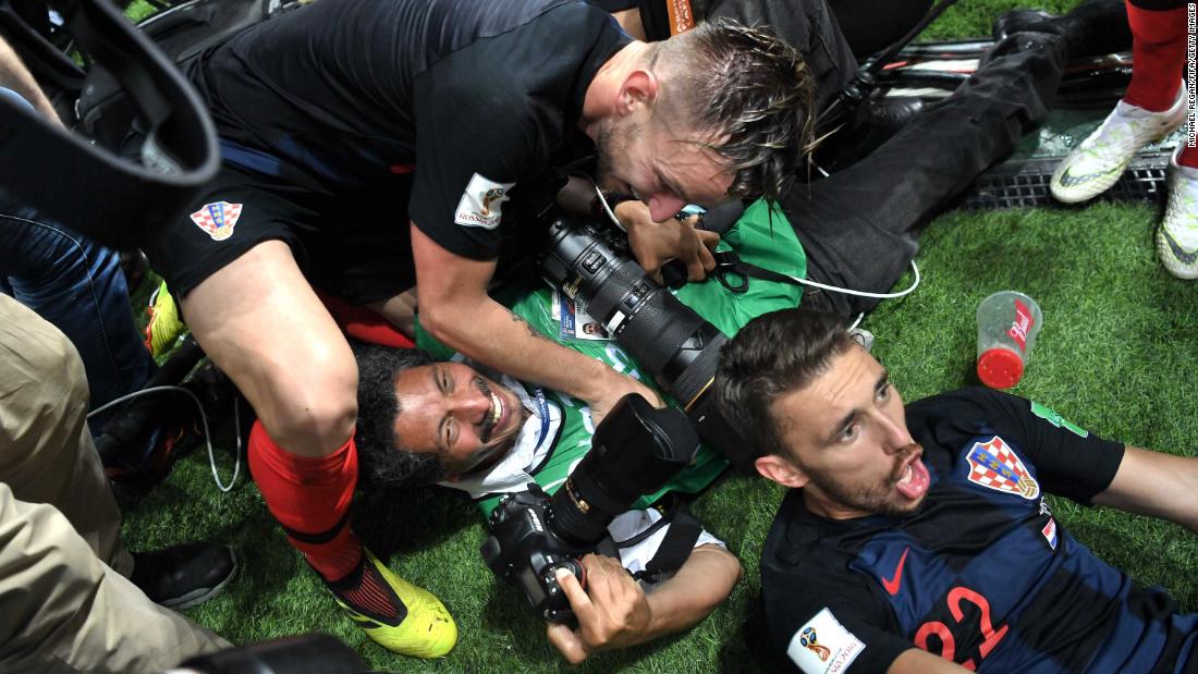 A photographer is knocked over by members of the Croatian team as they celebrate the late Mandzukic goal.