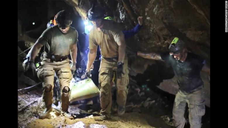 Rescue personnel  carry a member of the &quot;Wild Boars&quot; Thai youth football team on a stretcher during the rescue operation inside the Tham Luang cave. 