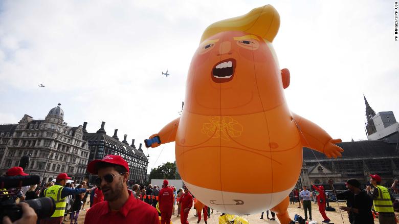 7/13/2018 - US Marine helicopters pass the &#39;Baby Trump&#39; balloon as it rises after being inflated in London&#39;s Parliament Square, as part of the protests against the visit of US President Donald Trump to the UK. (Photo by PA Images/Sipa USA) *** US Rights Only ***