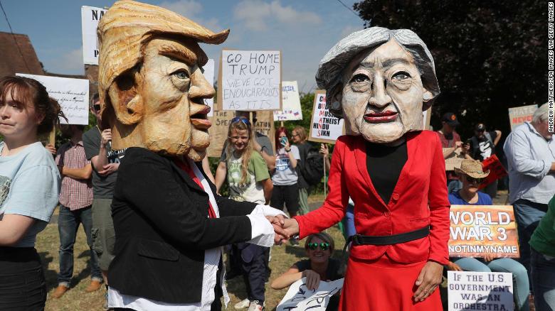 Protestors wearing Donald Trump and Theresa May costumes protest near the Prime Minister&#39;s country residence at Chequers in Buckinghamshire on Friday. 