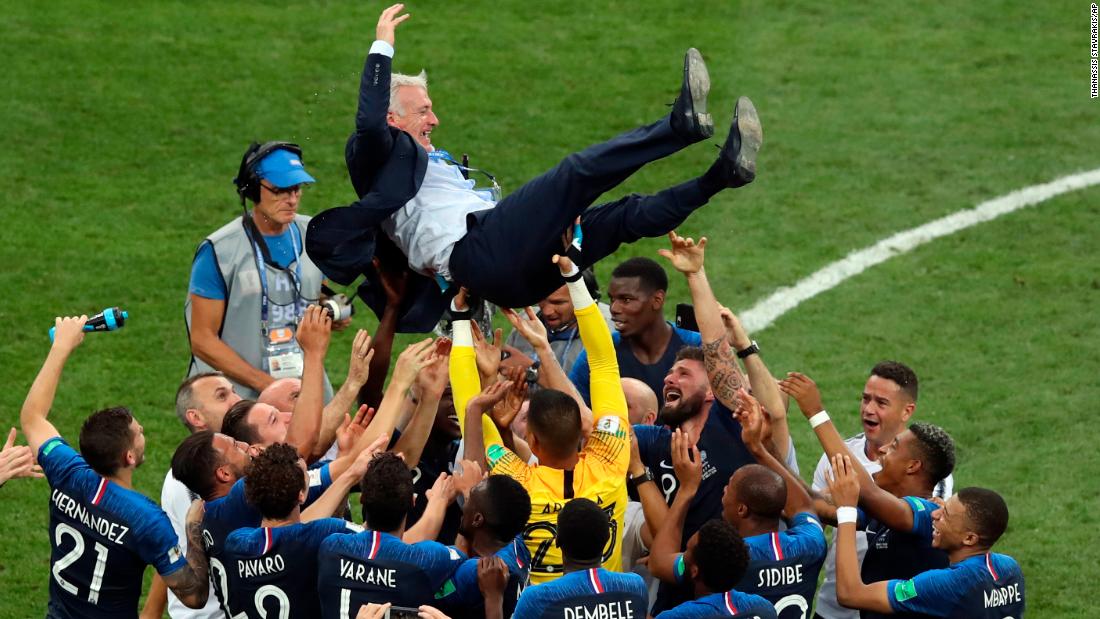 France manager Didier Deschamps is lifted by his players after the victory. Deschamps was also a player on the 1998 French team that won the World Cup.