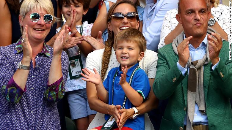 Novak Djokovic's son Stefan, 3, watches his father hoist the Wimbledon trophy in July 2018. 