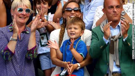 Novak Djokovic&#39;s three-year-old son Stefan watches his Dad hoist the Wimbledon trophy. 