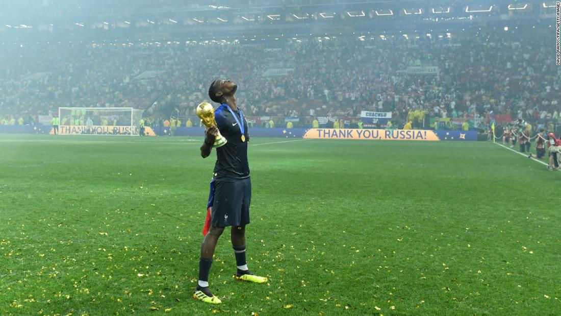 French midfielder Paul Pogba celebrates with the trophy.
