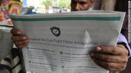 An man reads a newspaper with a full back page advertisement from WhatsApp intended to counter fake information, New Delhi  July 10, 2018. 