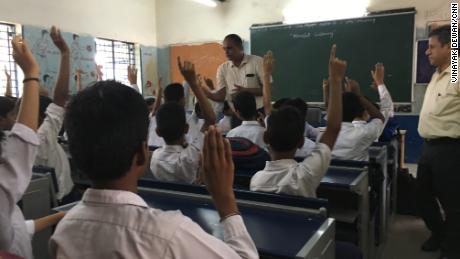 Sunil Kumar Joon, a teacher at a New Delhi government school speaks with his students Monday.