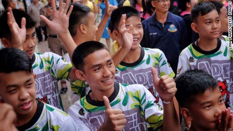 CHIANG RAI, THAILAND - JULY 18:  Twelve boys and their coach from the &quot;Wild Boars&quot; soccer team arrive for a press conference for the first time since they were rescued from a cave in northern Thailand last week, on July 18, 2018 in Chiang Rai, Thailand. The 12 boys, aged 11 to 16, and their 25-year-old coach were discharged early from Chiang Rai Prachanukroh hospital after a speedy recovery and thanked those involved in their rescue. (Photo by Linh Pham/Getty Images)