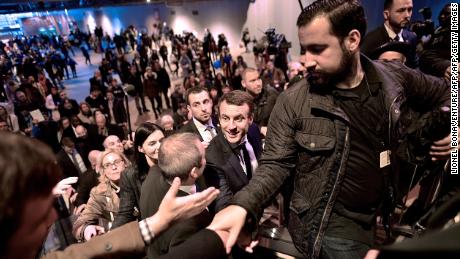 Emmanuel Macron, centre, shakes hands as he visits Paris&#39; international agriculture fair in March 2017 as his head of security Alexandre Benalla, right, clears the way.