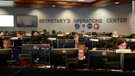 HHS staffers work to help reunite separated families at operations center in Washington.