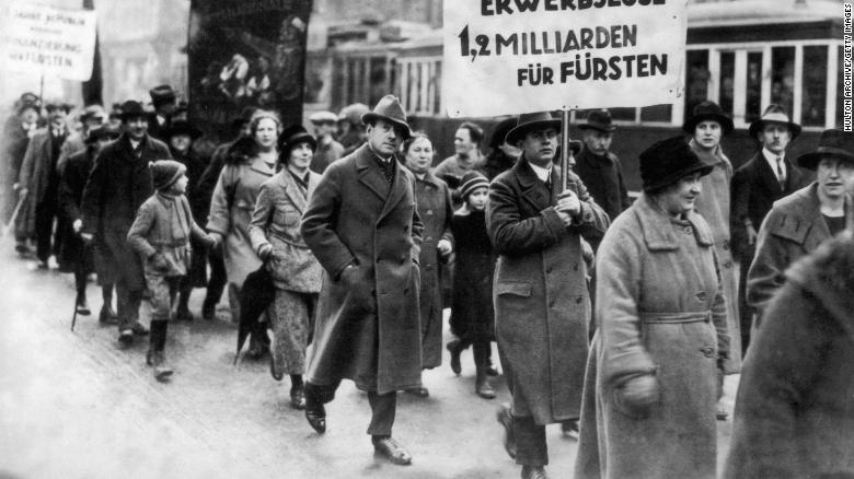 Male and female protesters during a demonstration by unemployed people in Berlin, Germany, in 1930. 