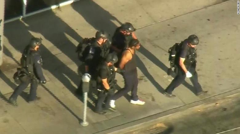 Aerial footage showed police leading the suspect away in handcuffs.