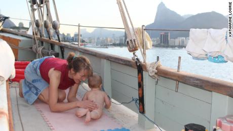 Baby Theo playing on deck, with Rio de Janeiro in the background. 