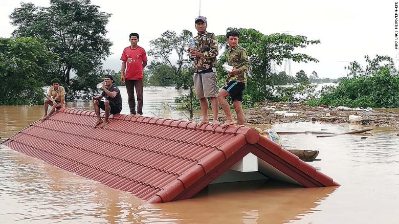 Laos villagers stranded on a roof of a house on July 24 after the Xe Pian Xe Nam Noy dam collapsed in a village near Attapeu province.