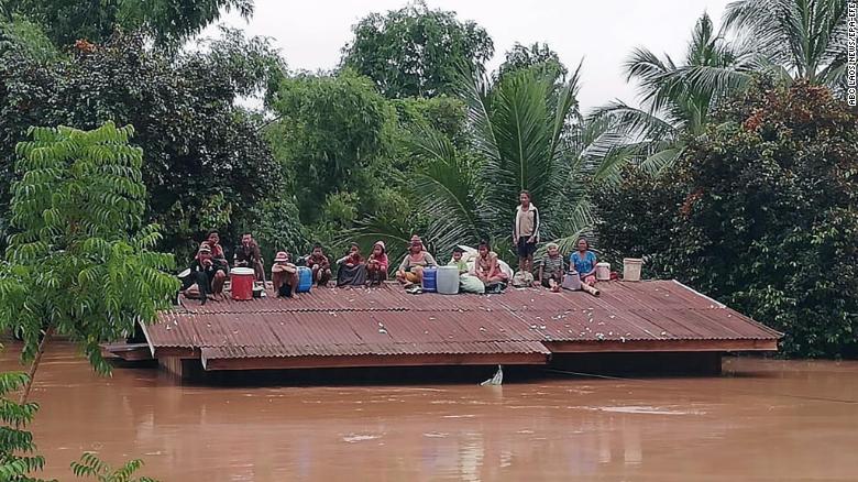 Lao villagers stranded on a roof of a house in Attapeu province on 24 July.