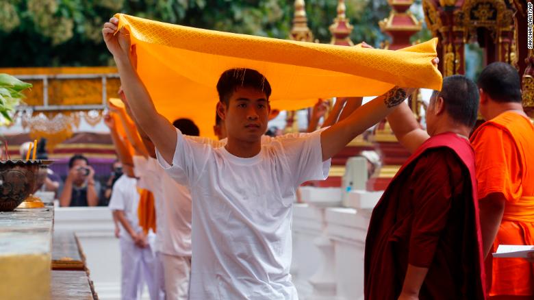 Soccer coach Ekkapol Chantawong, front, and members of the rescued soccer team attend a Buddhist ceremony on July 24.