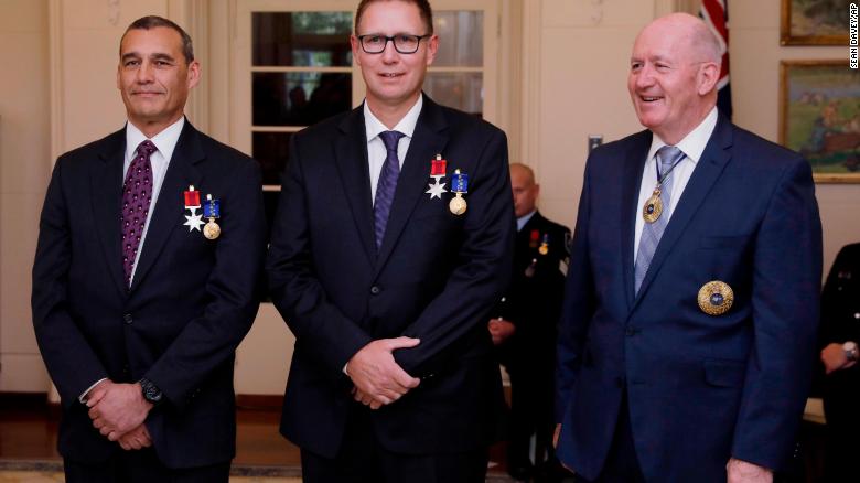 Australian members of the Thai cave rescue team, Craig Challen, left, and Dr. Richard Harris, center, at a function at Government House in Canberra, Australia on July 24.