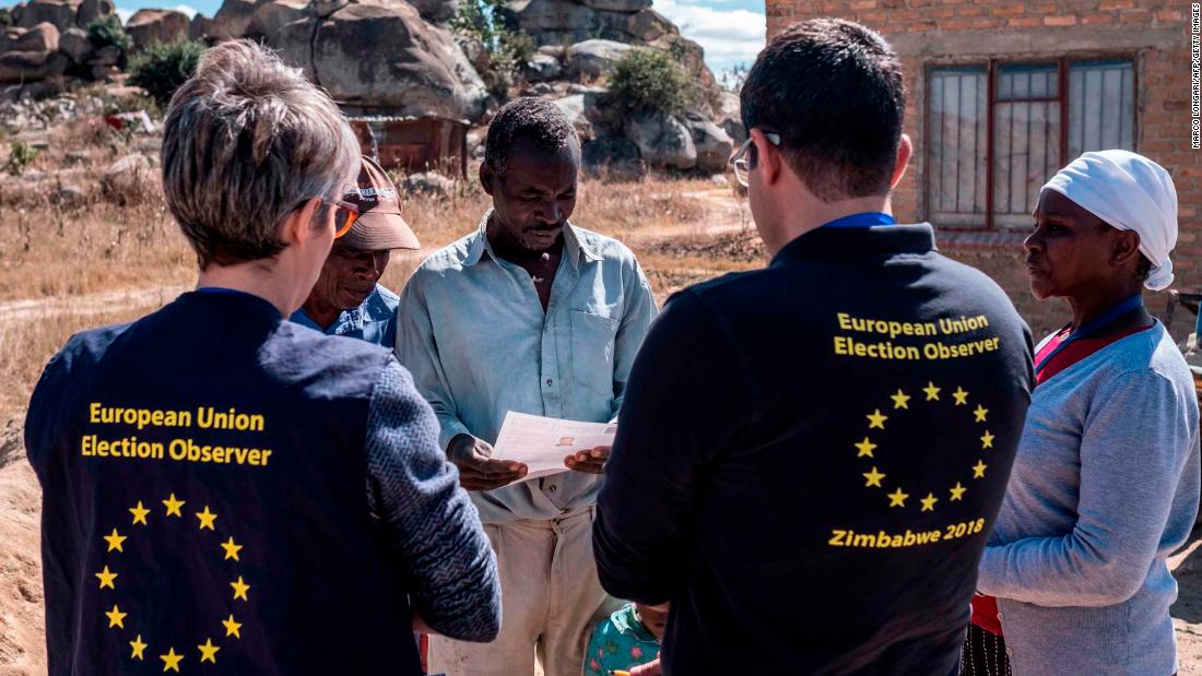 Members of a European Union election observation team speak to voters in Nyatsime, on July 24, 2018. 