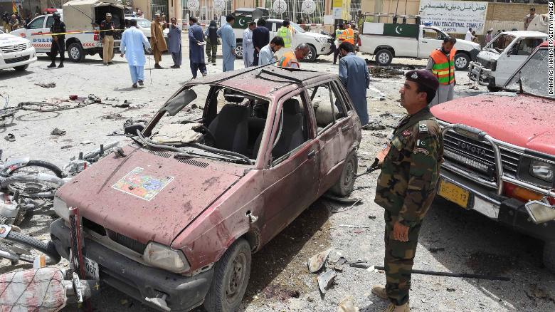 Pakistani volunteers and security officers visit the site of the bombing Wednesday in Quetta.
