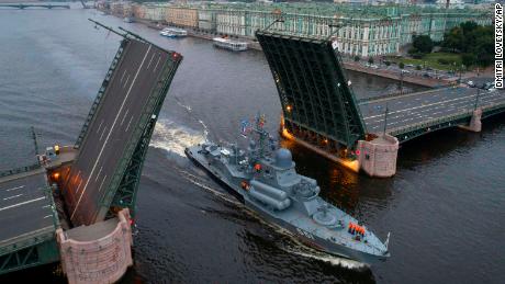 A Russian warship sails past the Dvortsovy drawbridge rising above the Neva River during rehearsals for the Navy Day parade in St. Petersburg.