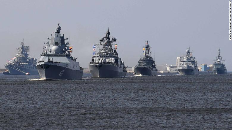 The Russian Navy frigate Admiral Gorshkov, second left, sails with other warships in rehearsal for Sunday&#39;s Navy Day parade in St. Petersburg.