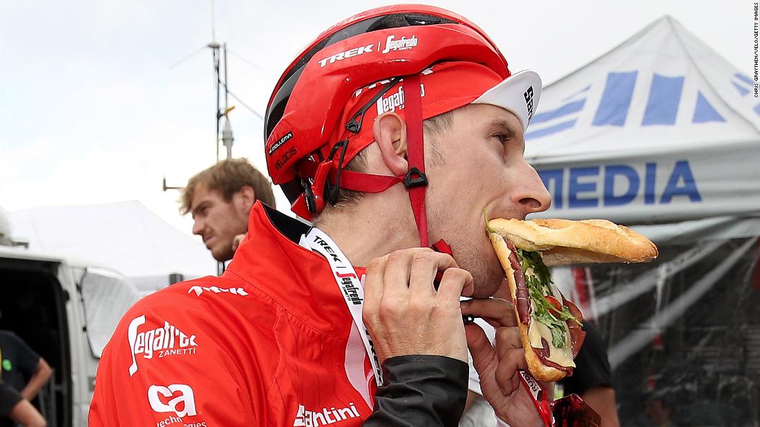 Dutch cyclist Bauke Mollema devours a sandwich after finishing the 17th stage.
