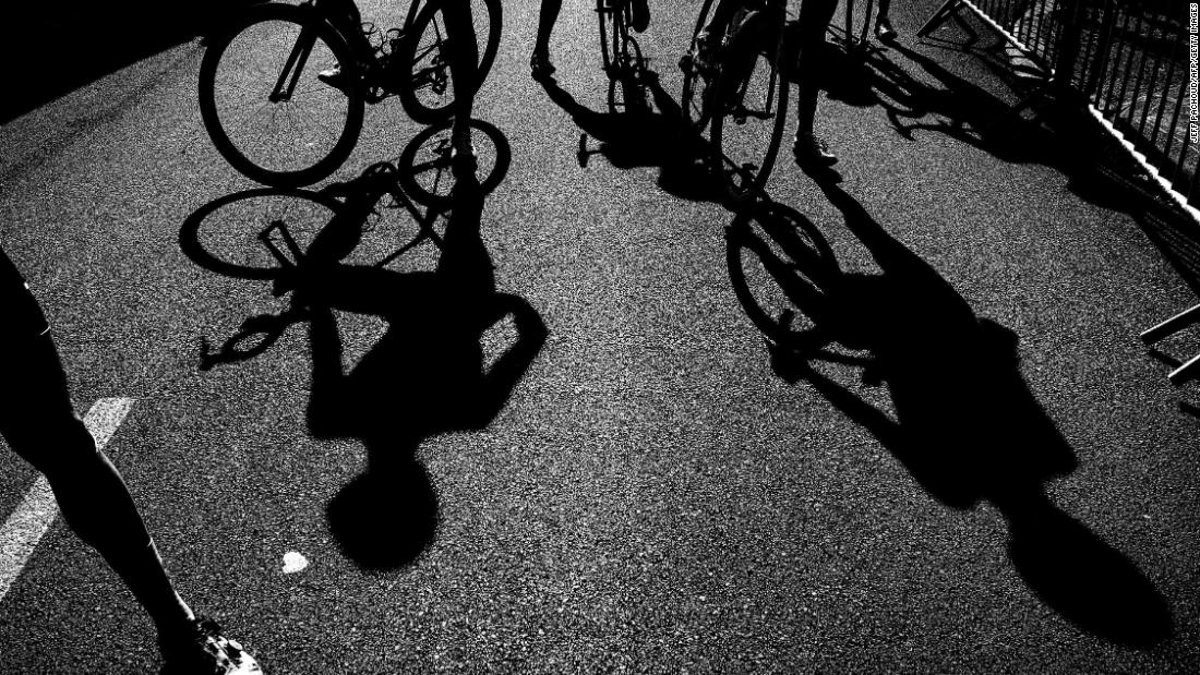 Riders&#39; shadows are seen near the finish line after the 15th stage.
