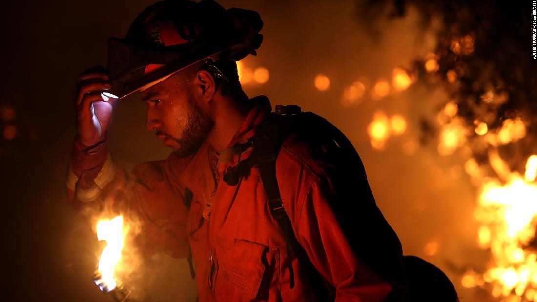 A firefighter monitors a backfire while battling the Carr Fire on July 27. The fire grew rapidly, ravaging several small communities and jumping the Sacramento River before threatening the outskirts of Redding.