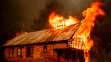 An historic schoolhouse burns as the Carr Fire tears through Shasta, Calif., Thursday, July 26, 2018. Fueled by high temperatures, wind and low humidity, the blaze destroyed multiple homes and at least one historic building. (AP Photo/Noah Berger)