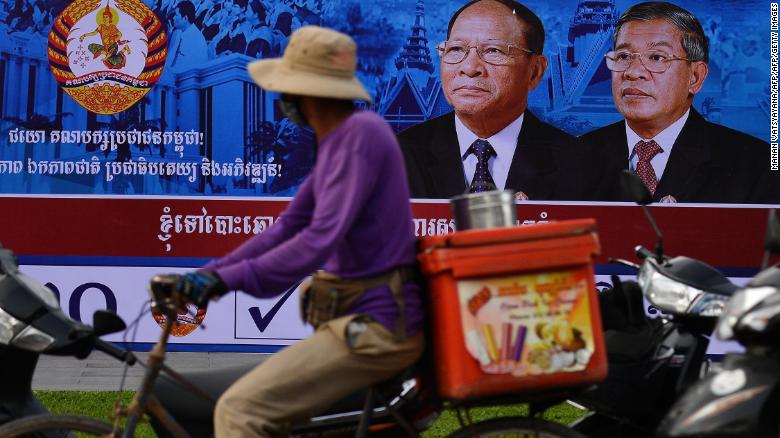 A cyclist rides past an electoral hoarding of Cambodia&#39;s Prime Minister and leader of the ruling Cambodian People&#39;s Party (CPP) Hun Sen, in Phnom Penh on Thursday.