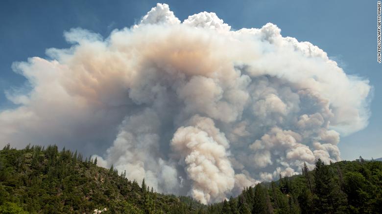 A large pyrocumulus cloud (or cloud of fire) explodes outward during the Carr fire near Redding, California on July 27, 2018. - Two firefighters have died and more than 100 homes have burned as wind-whipped flames tore through the region. (Photo by JOSH EDELSON / AFP)        (Photo credit should read JOSH EDELSON/AFP/Getty Images)