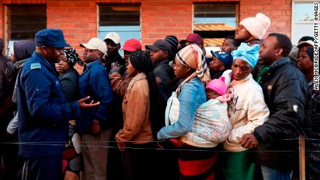 People queue to vote early Monday morning.