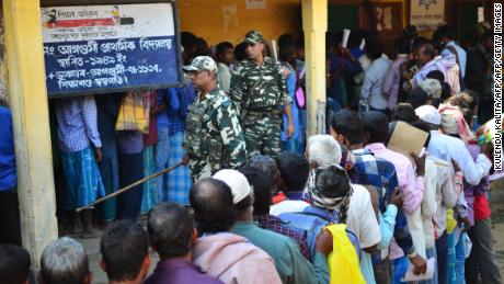 People stand in line to check their names on the first draft of the National Register of Citizens (NRC) at Gumi village of Kamrup district in the Indian state of Assam on January 1, 2018. 
