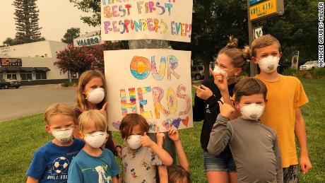 Nichole Grubbs-Miller and her sister&#39;s children made signs thanking firefighters for their service fighting the Carr Fire. 