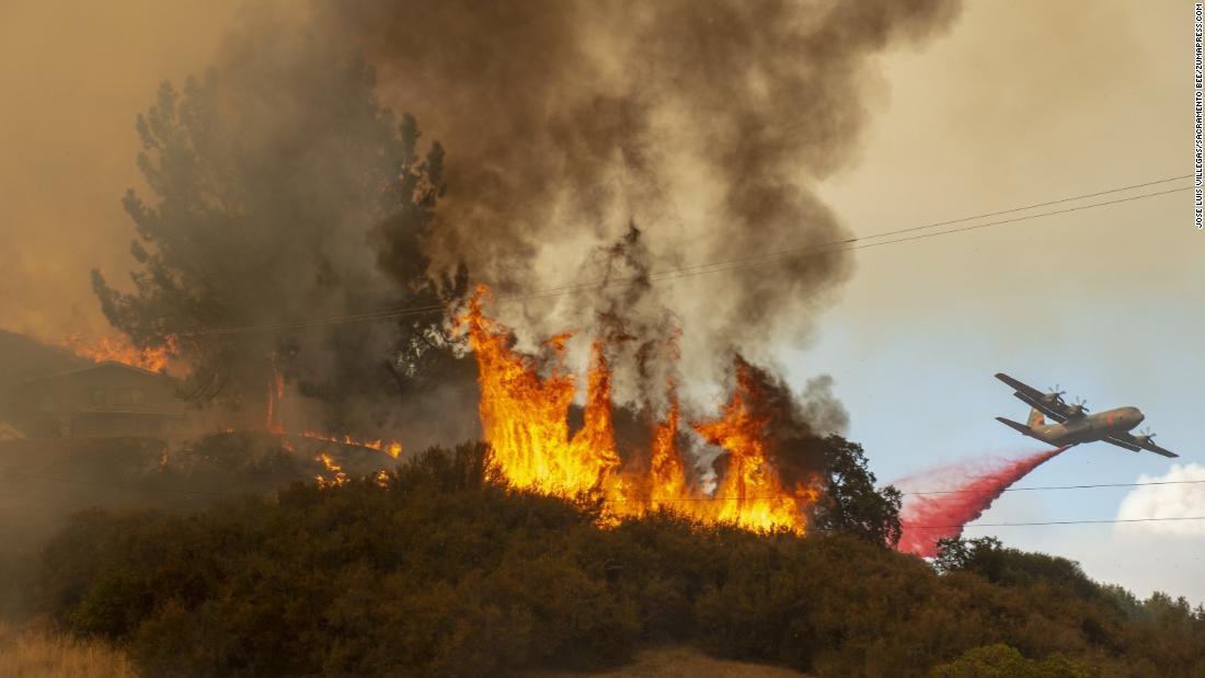 Fire retardant is dropped near a home as the Mendocino Complex Fire burns near Lakeport on Monday, July 30. 