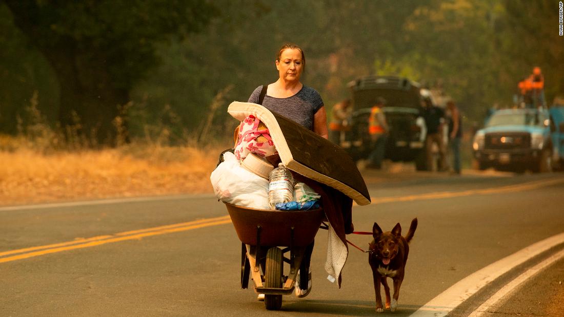 A woman leaves Lakeport as the River Fire approaches on July 31. 