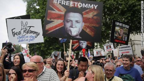 Protesters hold up placards at a gathering by supporters of far-right spokesman Tommy Robinson in central London on June 9, 2018.