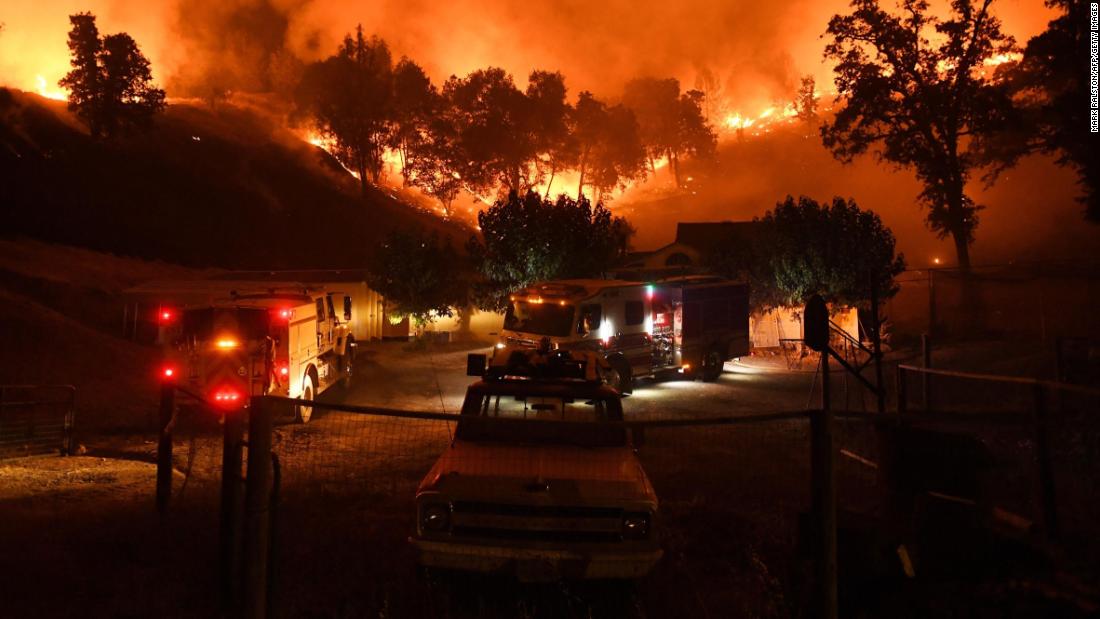 Firefighters conduct a controlled burn to defend houses from the Ranch Fire as it moves toward Upper Lake.