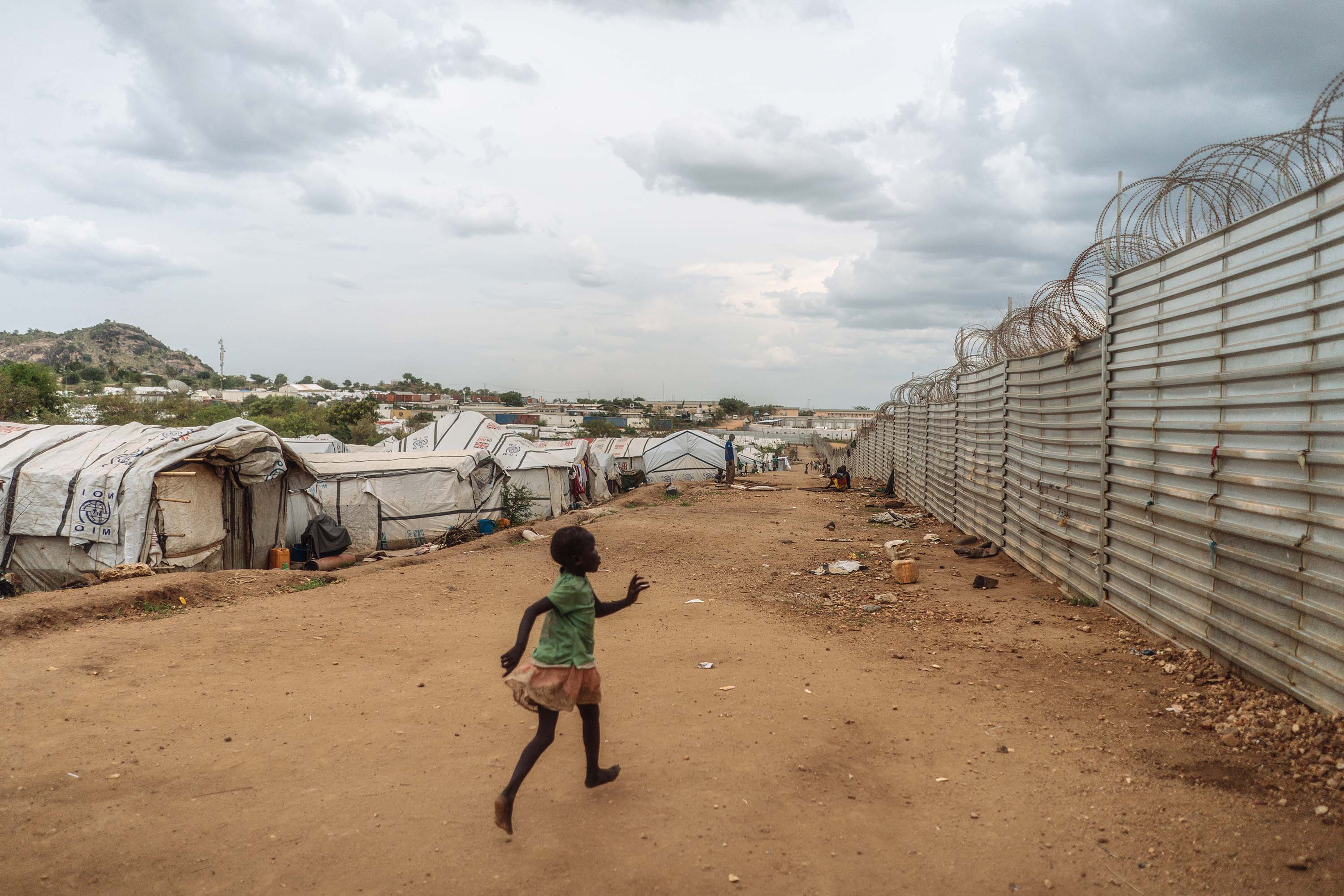 A young girl runs inside the camp, the largest in the capital city.