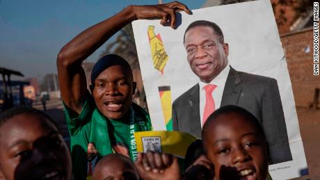 People in Mbare, a Harare suburb, celebrate Friday after officials announce Mnangagwa's victory.