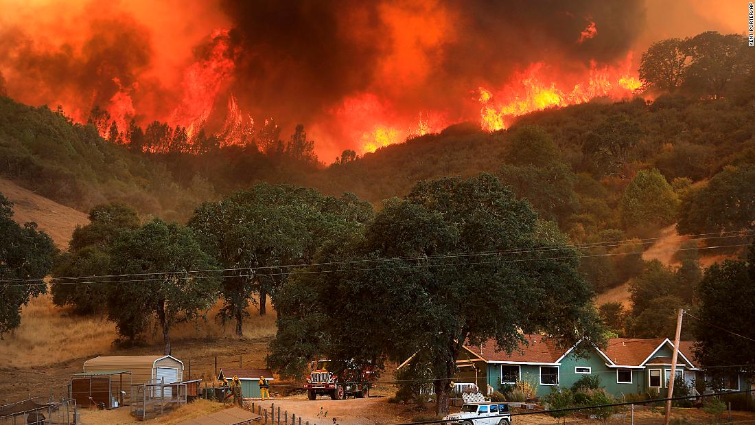 Flames from a wildfire advance down a hillside near Lakeport on August 2.